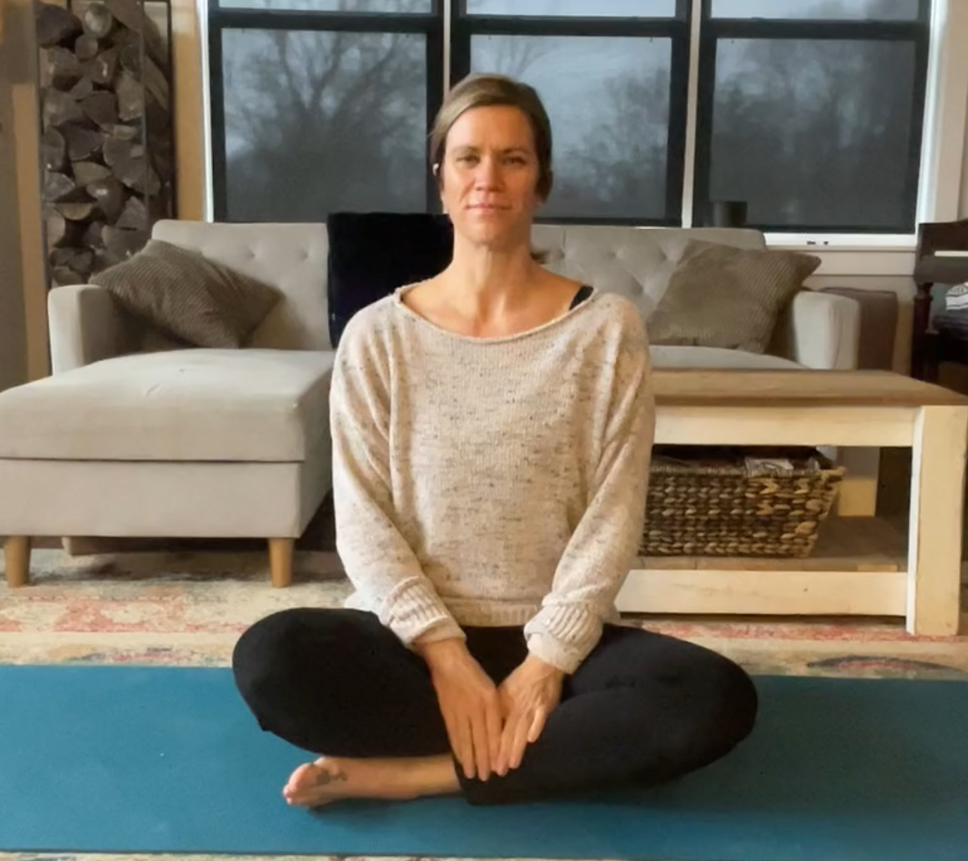 person sitting calming on yoga mat